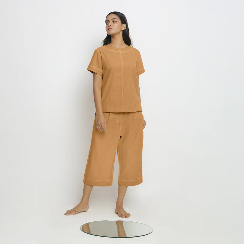 Front View of a Model wearing Orange Paneled Top and Mid-Rise Culottes Set
