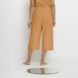 Back View of a Model wearing Vegetable Dyed Orange 100% Cotton Mid-Rise Culottes
