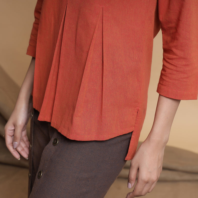 Front Detail of a Model wearing Brown Pleated Neck A-Line Top
