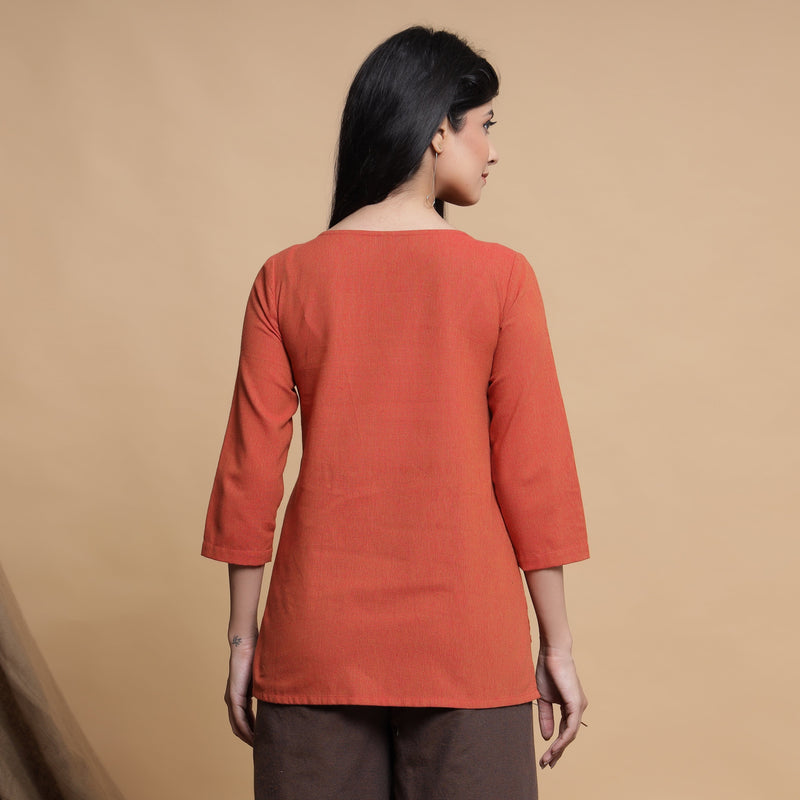 Back View of a Model wearing Orange Box-Pleated High Low Top