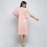 Back View of a Model wearing Peach Lined Cotton Chambray Dress