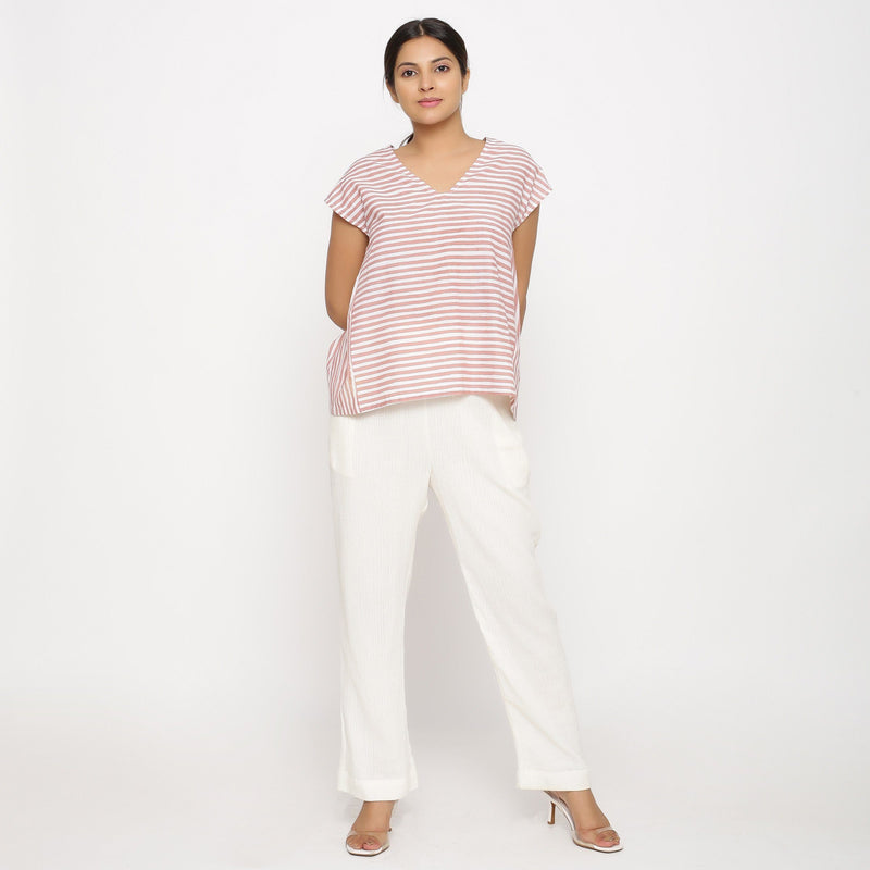 Front View of a Model Wearing Pink and White Top and Off-White Pant Set