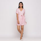 Front View of a Model wearing Pink Button-Down Short V-Neck Romper