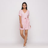 Front View of a Model wearing Pink Button-Down Short V-Neck Romper