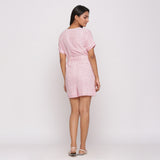 Back View of a Model wearing Pink Button-Down Short V-Neck Romper