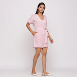 Right View of a Model wearing Pink Button-Down Short V-Neck Romper