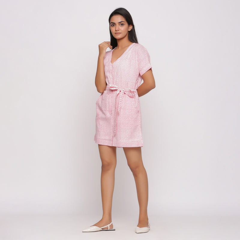 Left View of a Model wearing Pink Button-Down Short V-Neck Romper