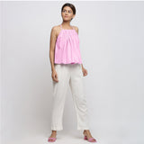 Front View of a Model wearing Pink Camisole Top and White Tapered Pant Set