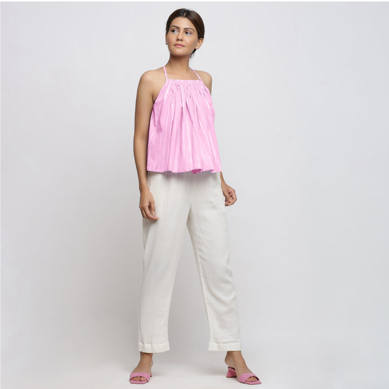 Front View of a Model wearing Pink Camisole Top and White Tapered Pant Set