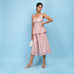 Left View of a Model wearing Powder Pink Block Printed 100% Cotton Peplum Top