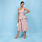 Left View of a Model wearing Powder Pink Peplum Top and Skirt Set