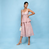 Left View of a Model wearing Powder Pink Peplum Top and Skirt Set