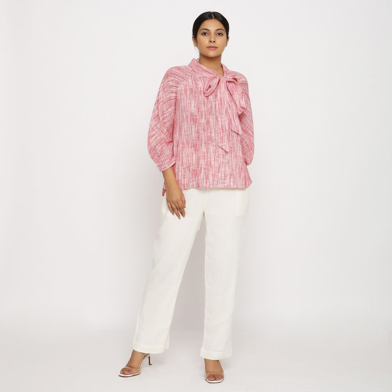 Front View of a Model wearing Red Crinkled Blouse and Off-White Pant Set
