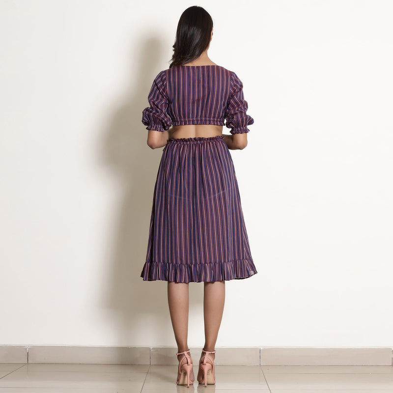 Back View of a Model wearing Reversible Plunge Neck Top and Wrap Skirt Set