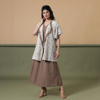 Front View of a Model wearing Reversible Shibori Wrap Dress and Overlay Set