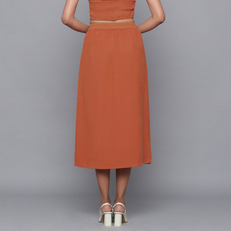 Back View of a Model wearing Sunset Rust Button-Down Midi Skirt