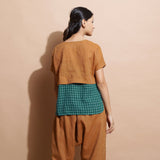 Back View of a Model wearing Rust Cotton Muslin Lined High Low Top