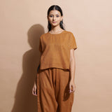 Front View of a Model wearing Rust Cotton Muslin Lined High Low Top
