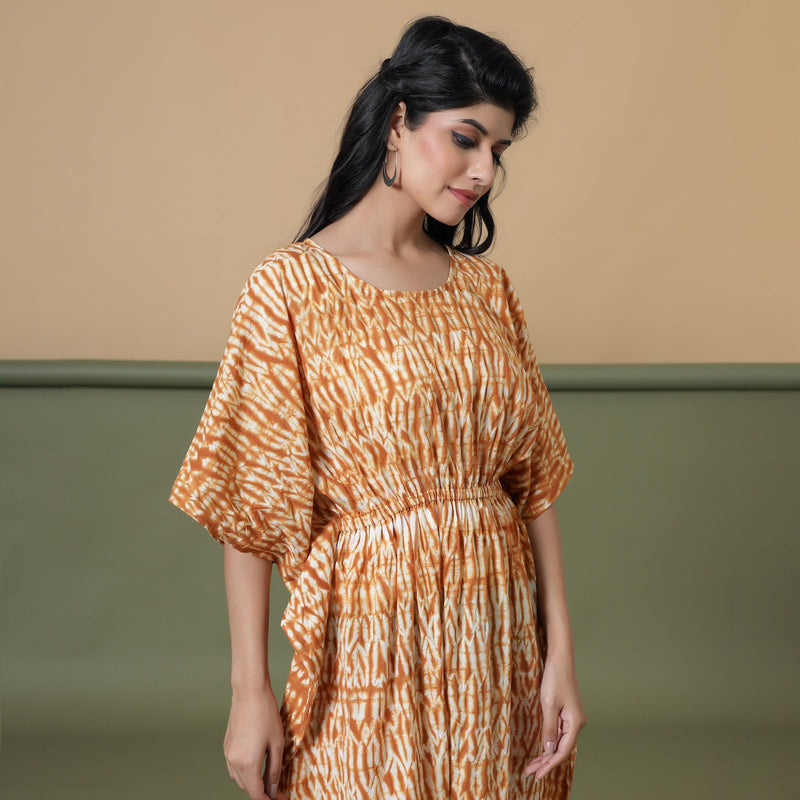 Right View of a Model wearing Rust Sandstone Shibori Kaftan Dress