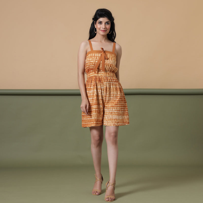 Front View of a Model wearing Rust Shibori Strappy Gathered Romper