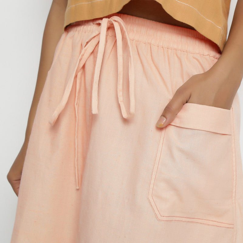 Front Detail of a Model wearing Vegetable Dyed Powder Pink Mid Rise Skirt