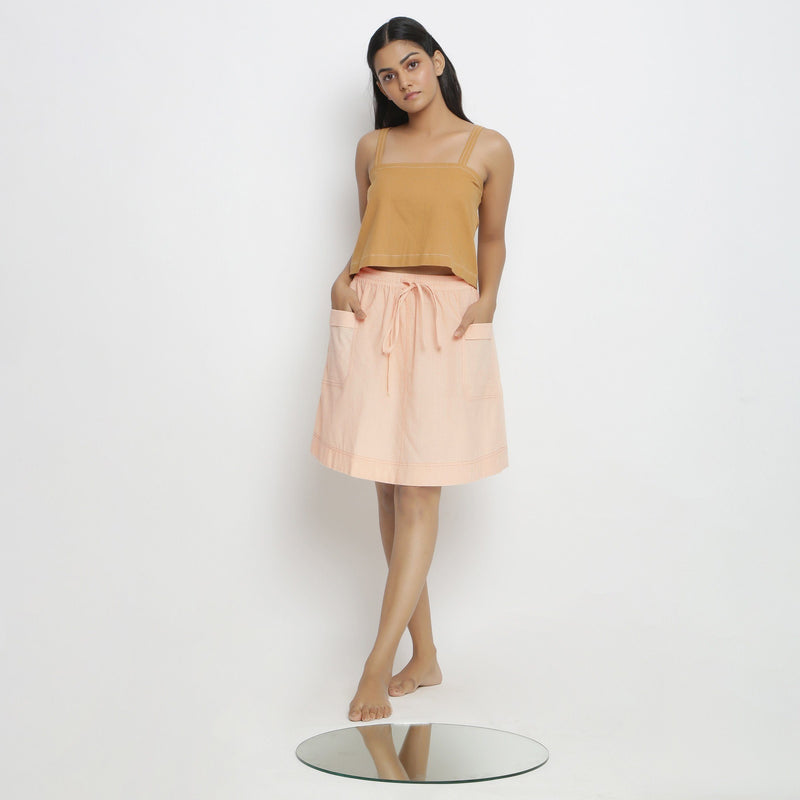 Front View of a Model wearing Rust Spaghetti Top and Powder Pink Skirt Set