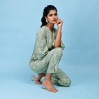 Right View of a Model wearing Sage Green Block Printed 100% Cotton Straight Jumpsuit