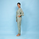 Left View of a Model wearing Sage Green Block Printed 100% Cotton Straight Jumpsuit