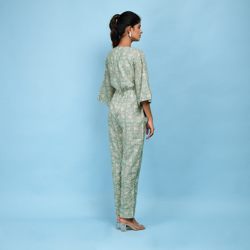 Back View of a Model wearing Sage Green Block Printed 100% Cotton Straight Jumpsuit