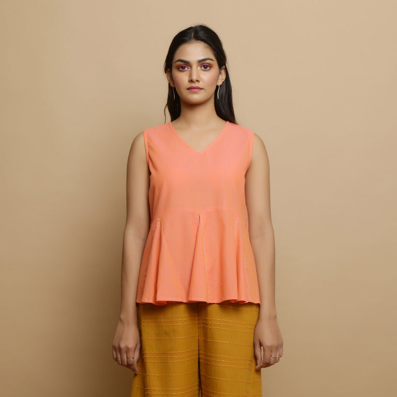 Front View of a Model wearing Salmon Pink Hand-Embroidered Flared Top
