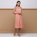 Right View of Model wearing Salmon Pink Handspun Pleated Dress