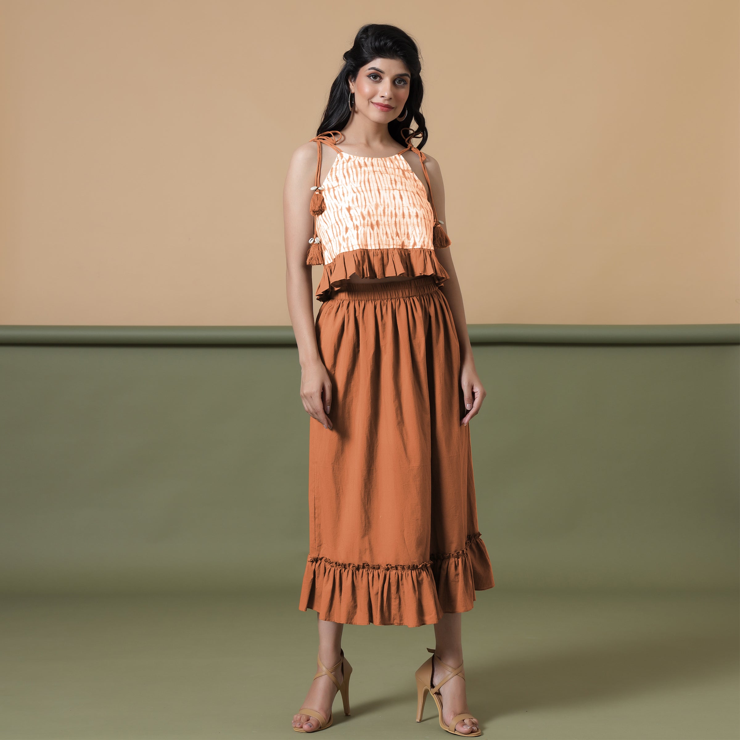 Front View of a Model wearing Orange Camisole Top and Ruffled Skirt Set