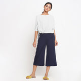 Front View of a Model wearing White Blouson Top and Navy Blue Culottes Set
