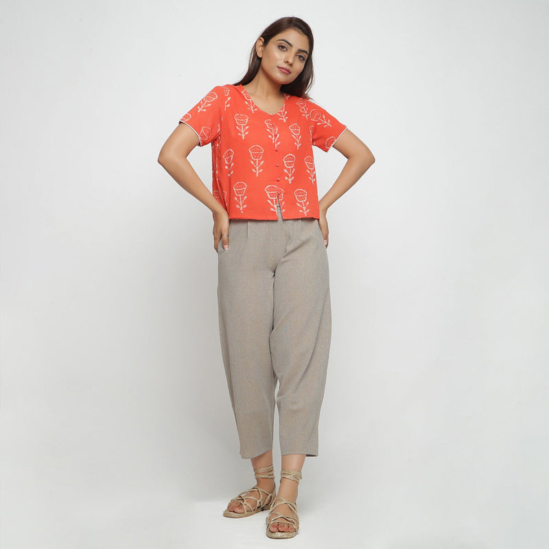 Front View of a Model wearing Sunny Orange Button-Down Top and Beige Pant Set