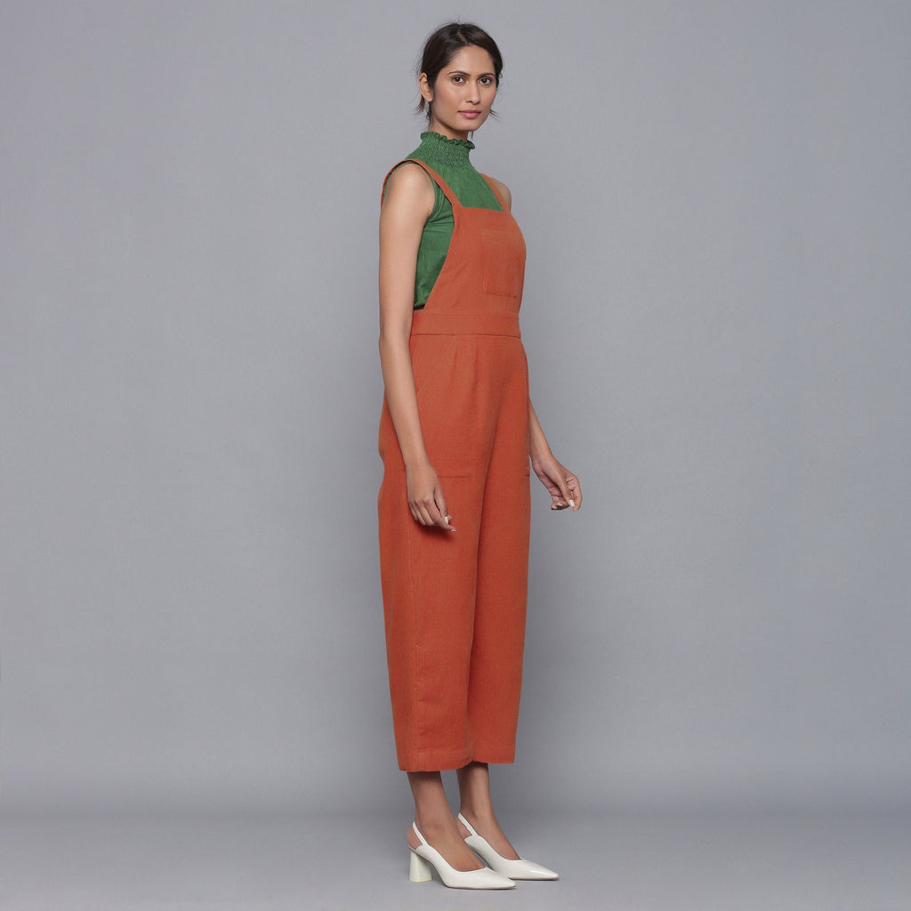 Right View of a Model wearing Sunset Rust Cotton Corduroy Dungaree