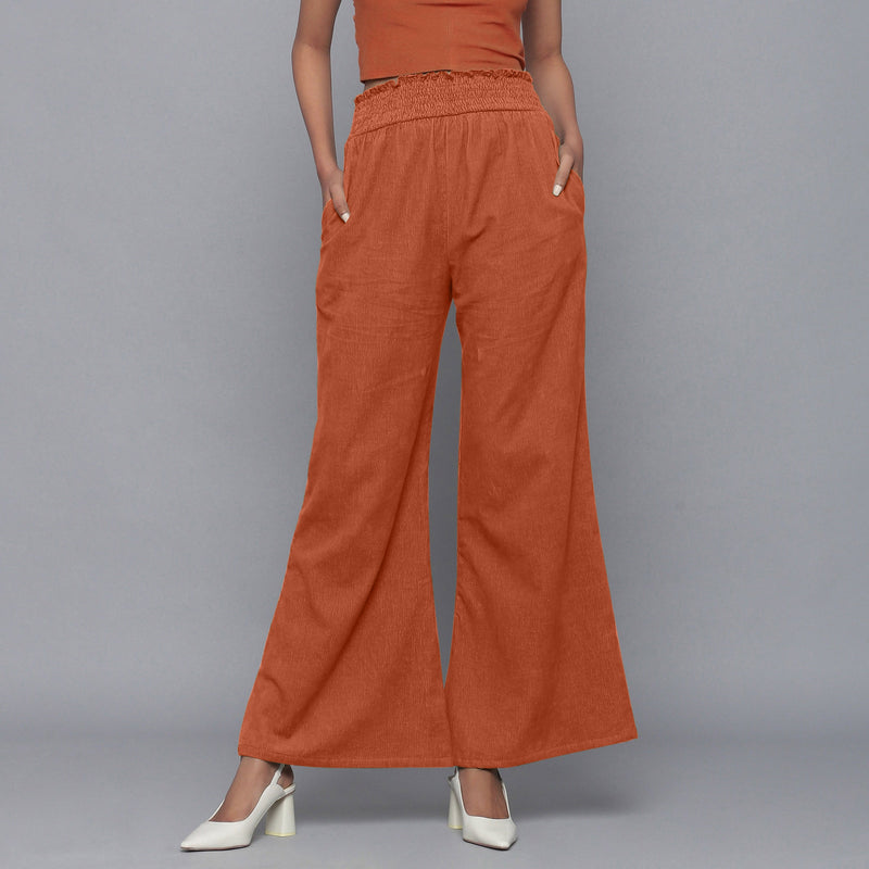 Front View of a Model wearing Sunset Rust Corduroy Striped Bootcut Pant