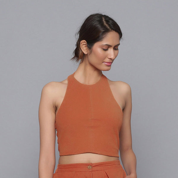 Front View of a Model wearing Sunset Rust Corduroy Halter Neck Top