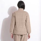 Back View of a Model wearing Dusk Beige Corduroy Quilted Puffer Jacket
