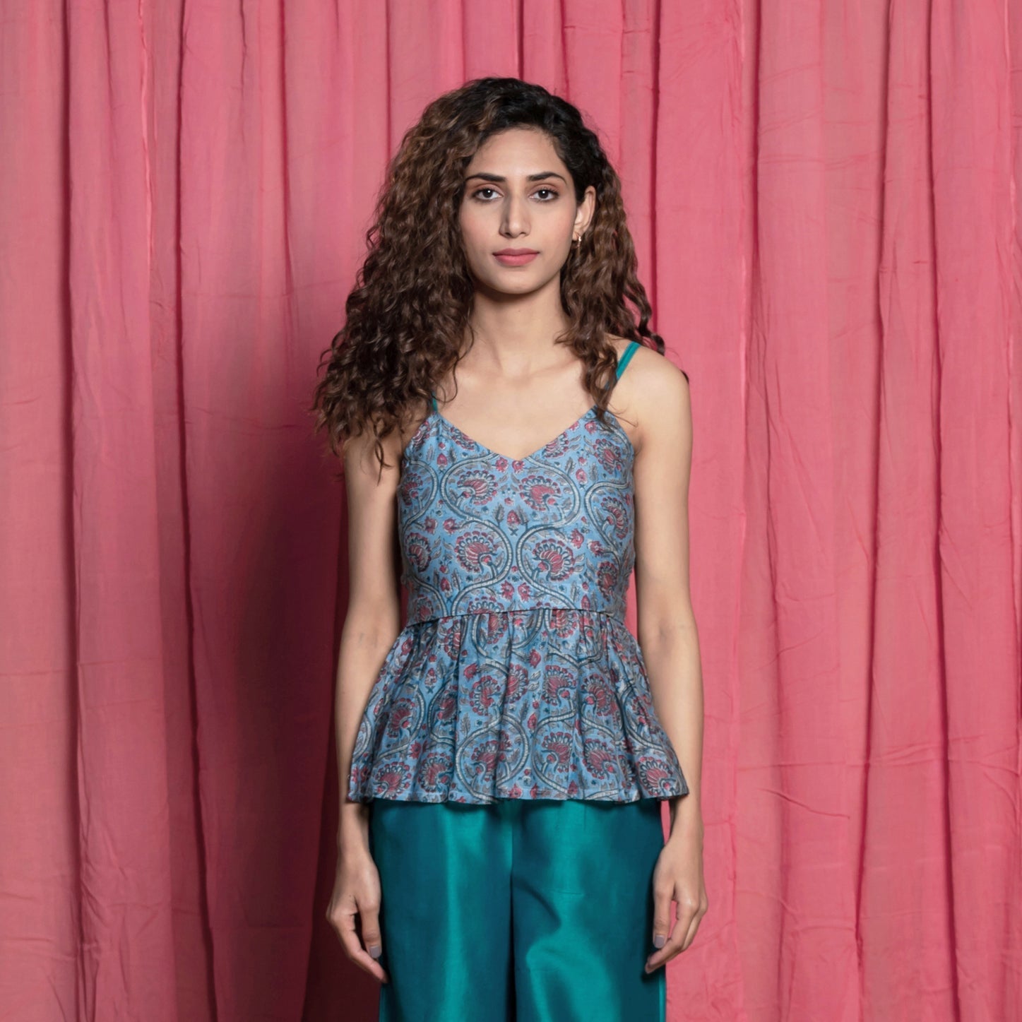 Front View of a Model wearing Teal Block Printed Chanderi Peplum Top