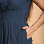 Front Detail of a Model wearing Teal Pleated Cap Sleeves Dress