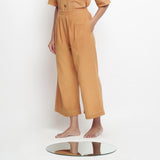 Left View of a Model wearing Vegetable Dyed Rustic Wide Legged Pant