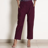 Front View of a Model wearing Warm Berry Wine Frilled Waist Tapered Pant