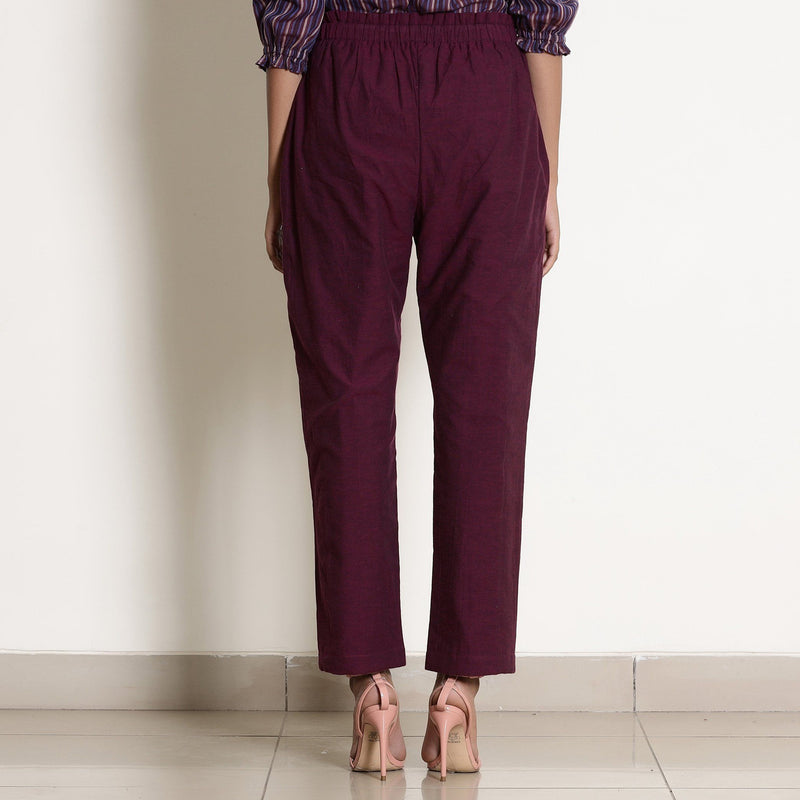 Back View of a Model wearing Warm Berry Wine Frilled Waist Tapered Pant