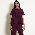 Front View of a Model wearing Warm Berry Wine Gathered Frilled Top