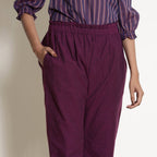 Front Detail of a Model wearing Warm Berry Wine Frilled Waist Tapered Pant