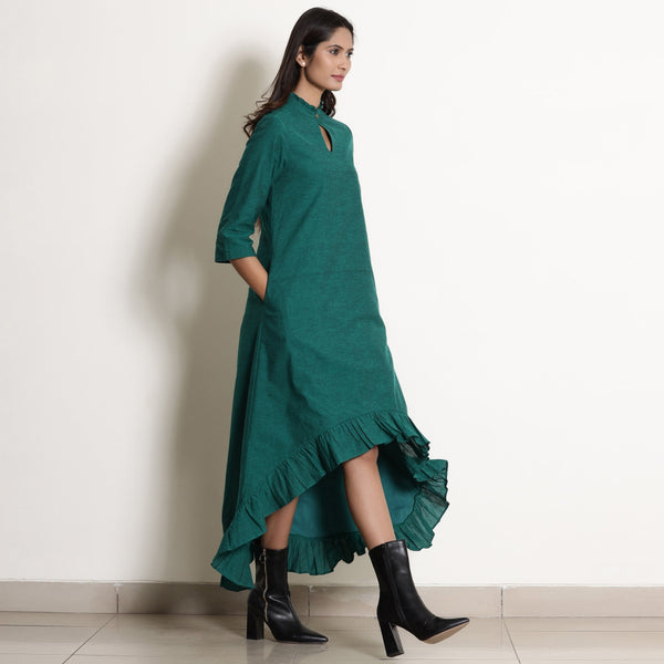 Right View of a Model wearing Warm Pine Green Frilled Neck High Low Dress