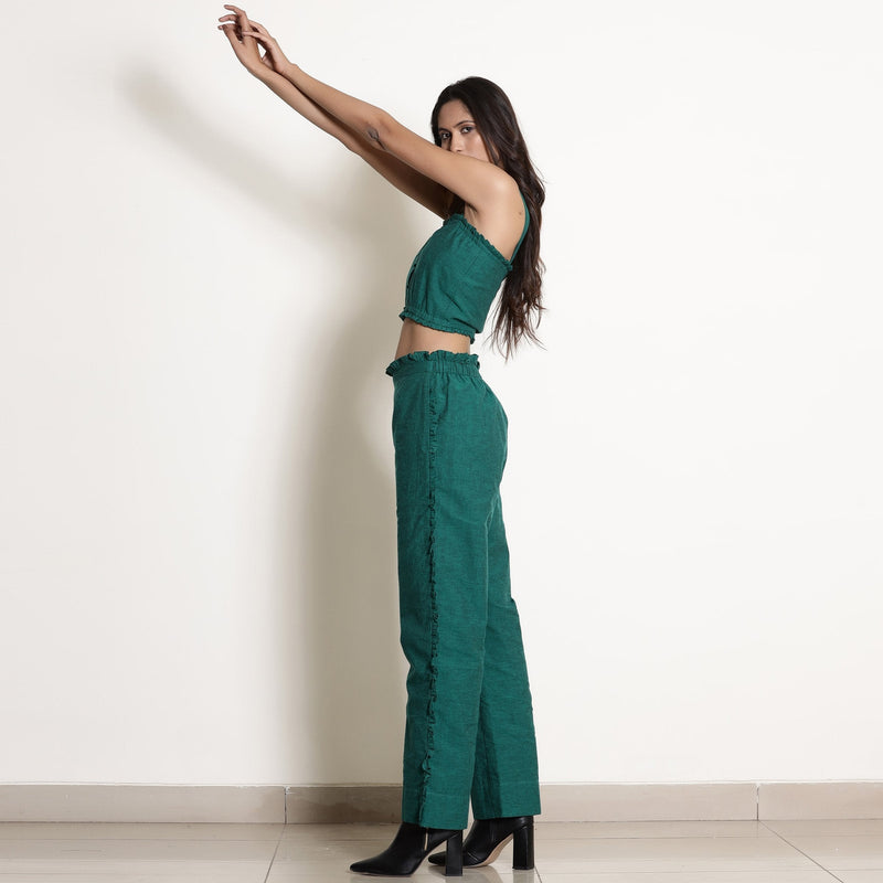 Left View of a Model wearing Warm Pine Green Frilled Straight Pant