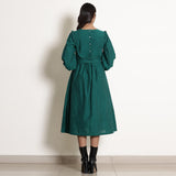 Back View of a Model wearing Warm Pine Green Frilled Yoke Dress