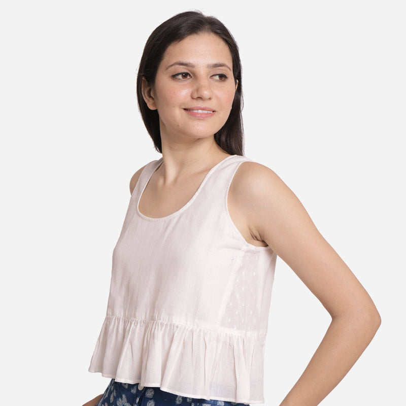 Left View of a Model Wearing White Round Neck Cotton Peplum Top