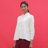 Left View of a Model wearing White Corduroy Hand-Beaded Shirt